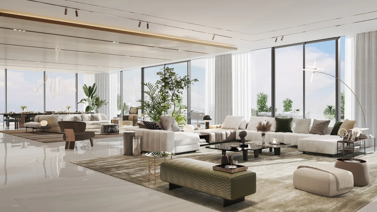 Living and lounge area with a green sofa and floor to ceiling glass to the sea